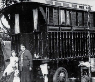 Picture of a woman and girl in front of a Gypsy wagon