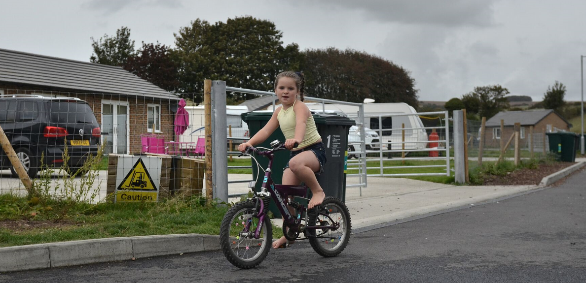 Picture of young girl on a site riding a bike