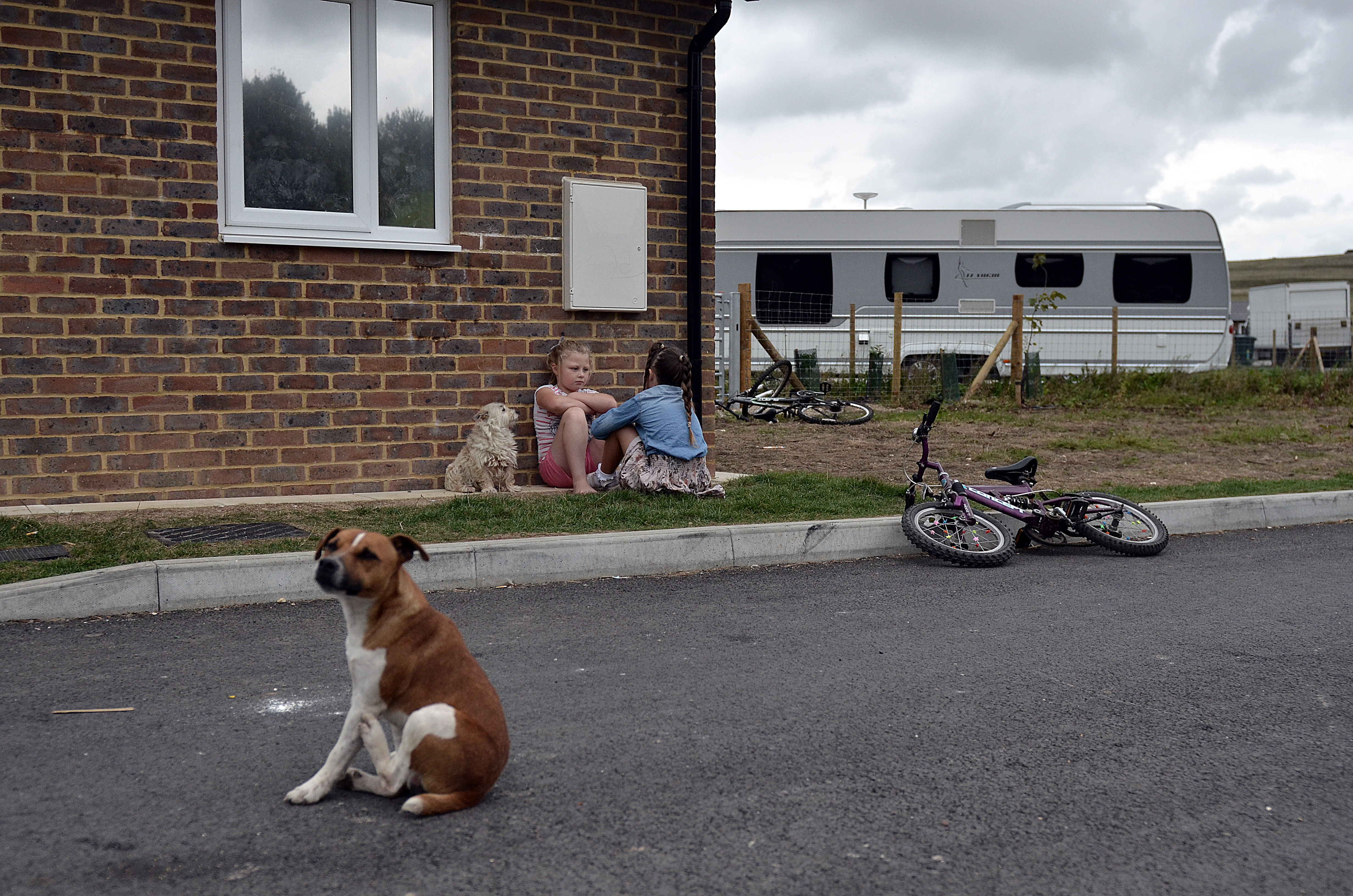 Two children sitting talking on a Traveller site