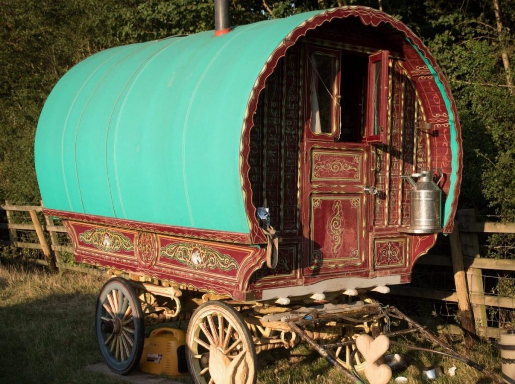 Picture of traditional Gypsy wagon next to a fence