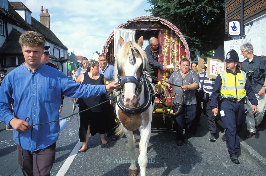 A horse and cart, led by Jake Bowers through Horsmonden, accompanied by police officers at a protest to keep the annual Horsmonden Fair alive