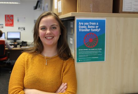 Picture of Chrissie Borne next to a Gypsy Roma Traveller poster