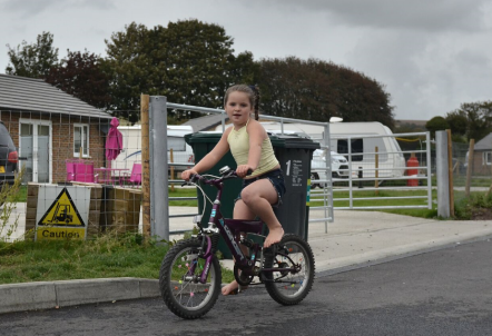 Picture of young girl on a site riding a bike