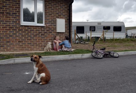 Two children sitting talking on a Traveller site