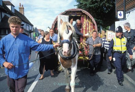A horse and cart, led by Jake Bowers through Horsmonden, accompanied by police officers at a protest to keep the annual Horsmonden Fair alive